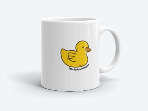 A white ceramic coffee mug with an illustration of a yellow duck