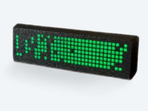 A black deskhub device displaying the signature green square grid visualization popularized by GitHub